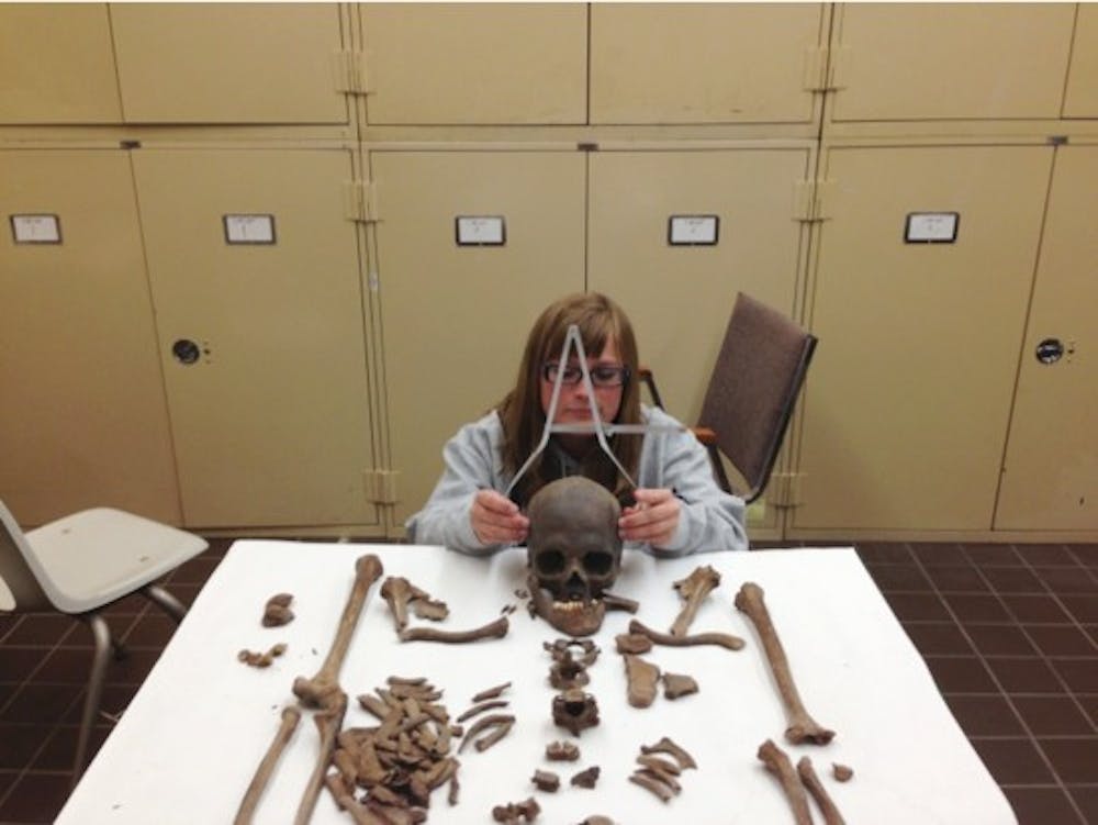 <p>A student in the department of anthropology analyzes skeletal remains. The remains were unearthed after a construction crew discovered human remains from a nineteenth century gravesite on UB's South Campus.&nbsp;</p>