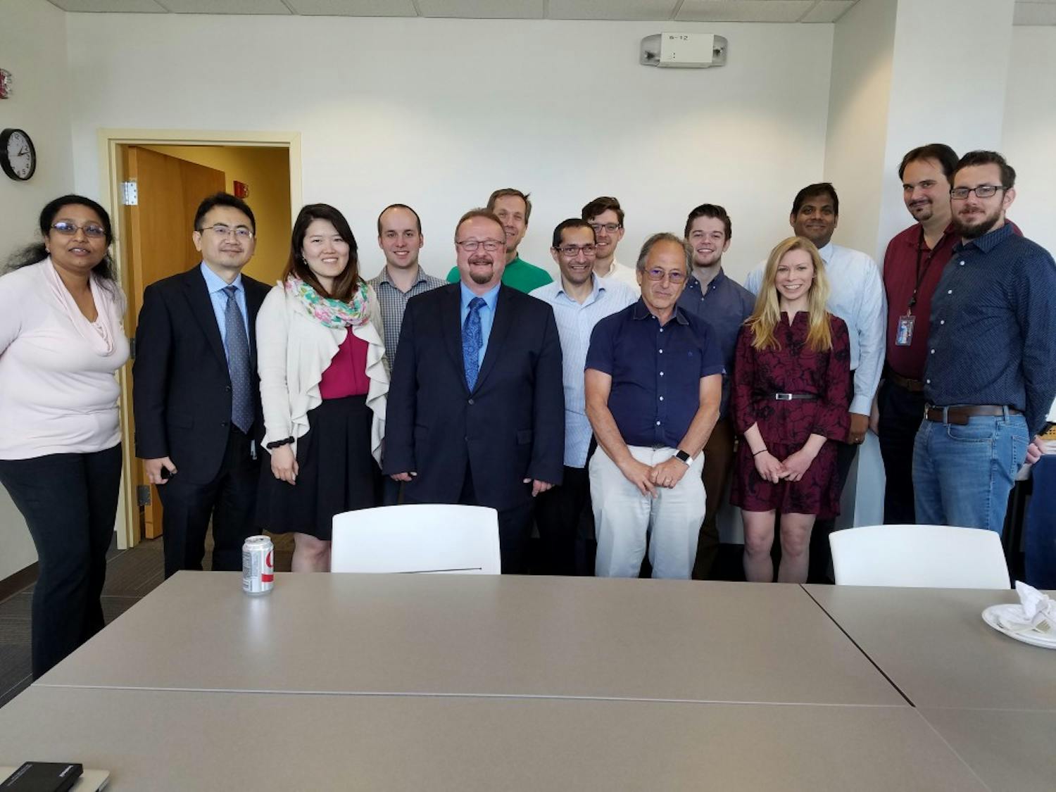 Dr. Peter Elkin (fifth from left) and Ph.D. students meet with Nobel Laureate and biophysicist Michael Levitt.