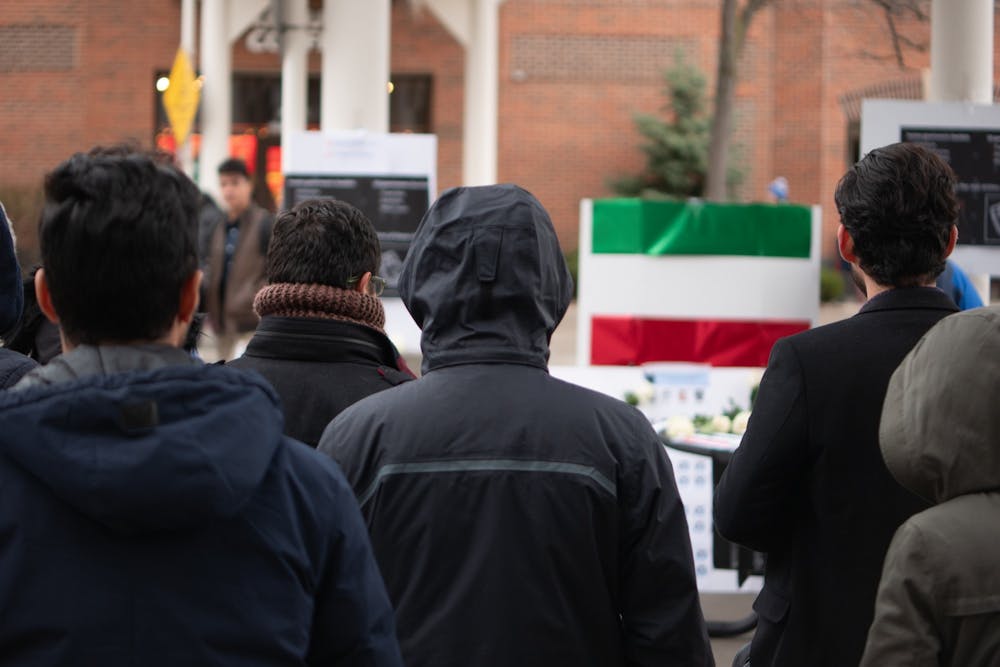 <p>Iranian students and their supporters stand in solidarity outside Student Union on Thursday. The students brought light to the situation in Iran.</p>