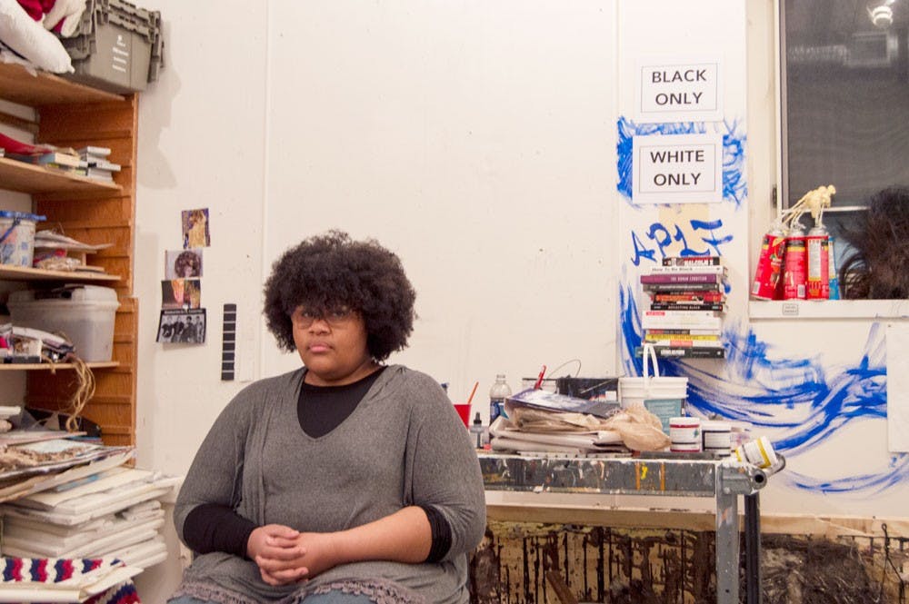 <p>Ashley Powell, who has received both criticism and support for her “White Only, Black Only” art project, sits in her art studio in the Center for the Arts.</p>