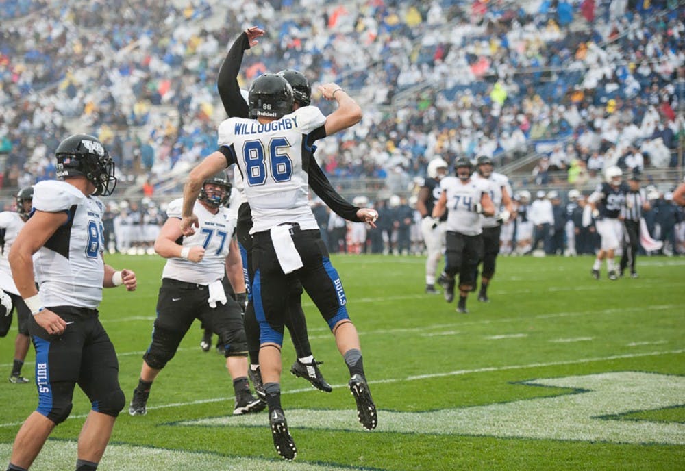 <p>Senior receiver Ron Willoughby celebrates after catching a touchdown pass from senior quarterback Joe Licata against Penn State. The Bulls would go on to lose 27-14.</p>