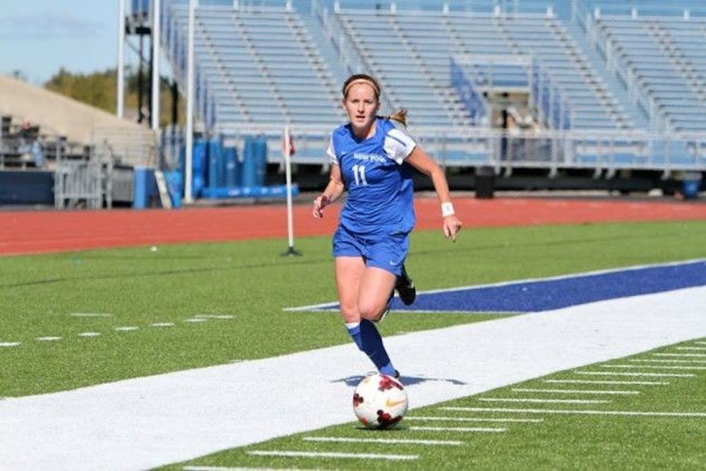<p>Senior midfielder Kassidy Kidd brings the ball down field in a game last season. She assisted on the Bulls' game-winning goal against Syracuse Sunday. </p>