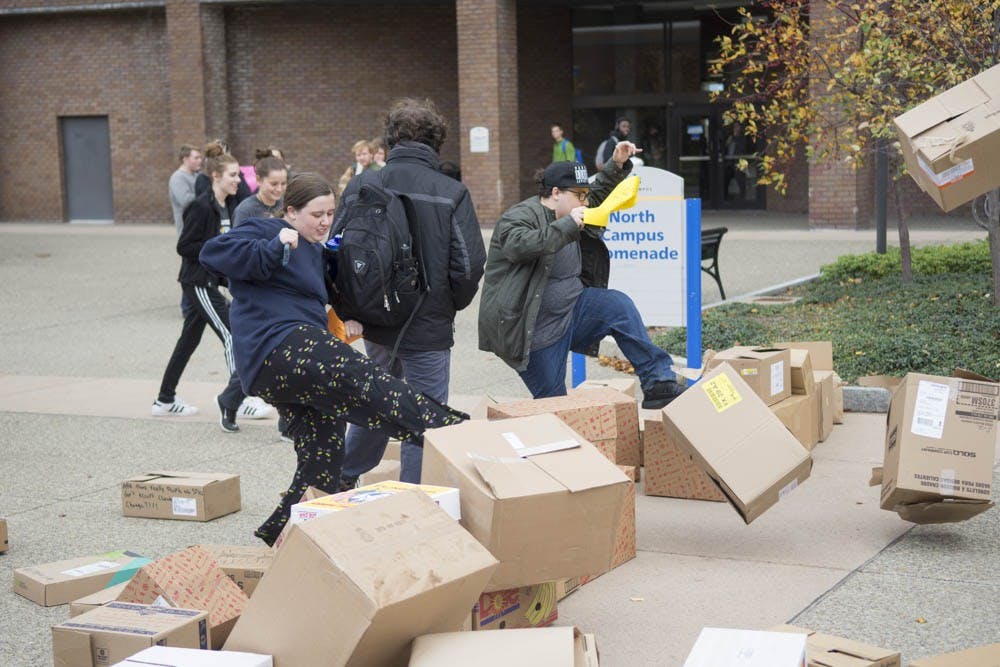 <p>Students joined together on North Campus Promenade to protest Trump’s presidency. They  wrote on boxes to show they do not accept hate and knocked the "wall of hate” down.</p>
