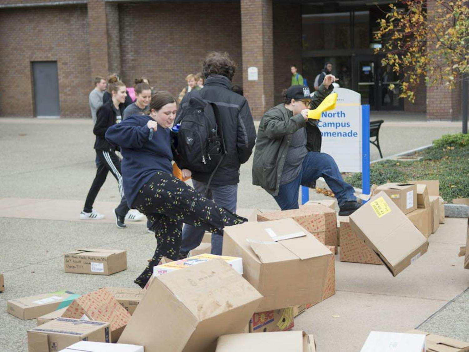 Students joined together on North Campus Promenade to protest Trump’s presidency. They wrote on boxes to show they do not accept hate and knocked the "wall of hate” down.