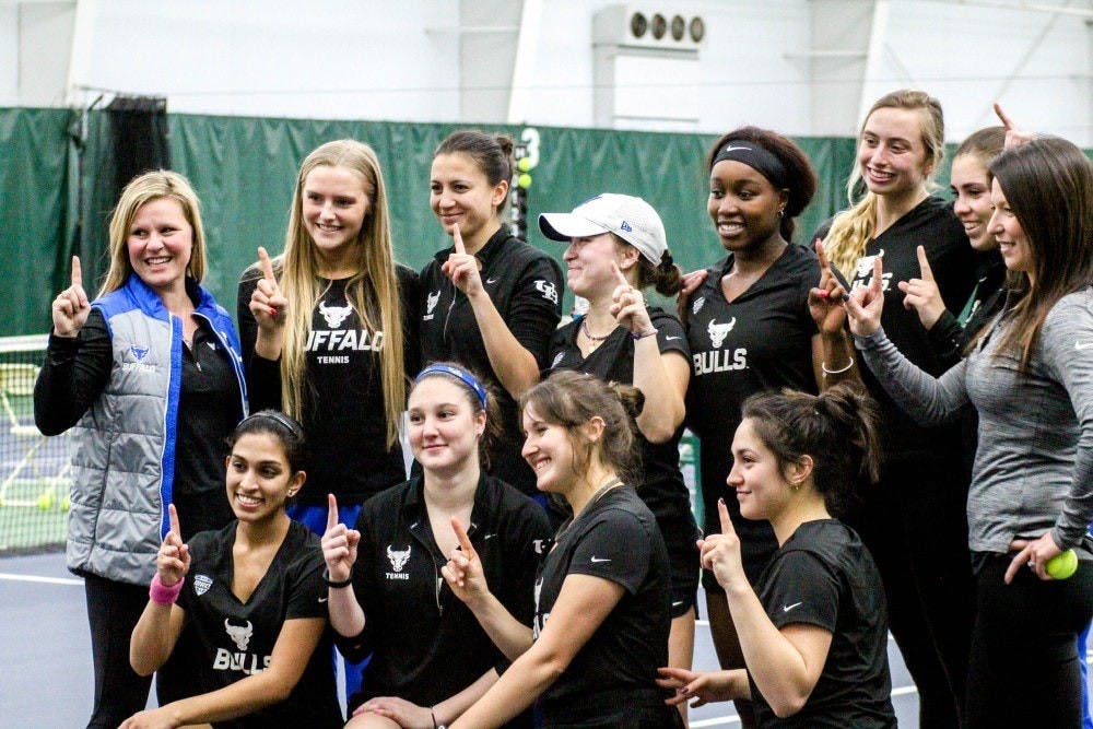 <p>The Bulls pose to celebrate their win. The women’s tennis team opened its 2019 spring season with two dominating performances.</p>