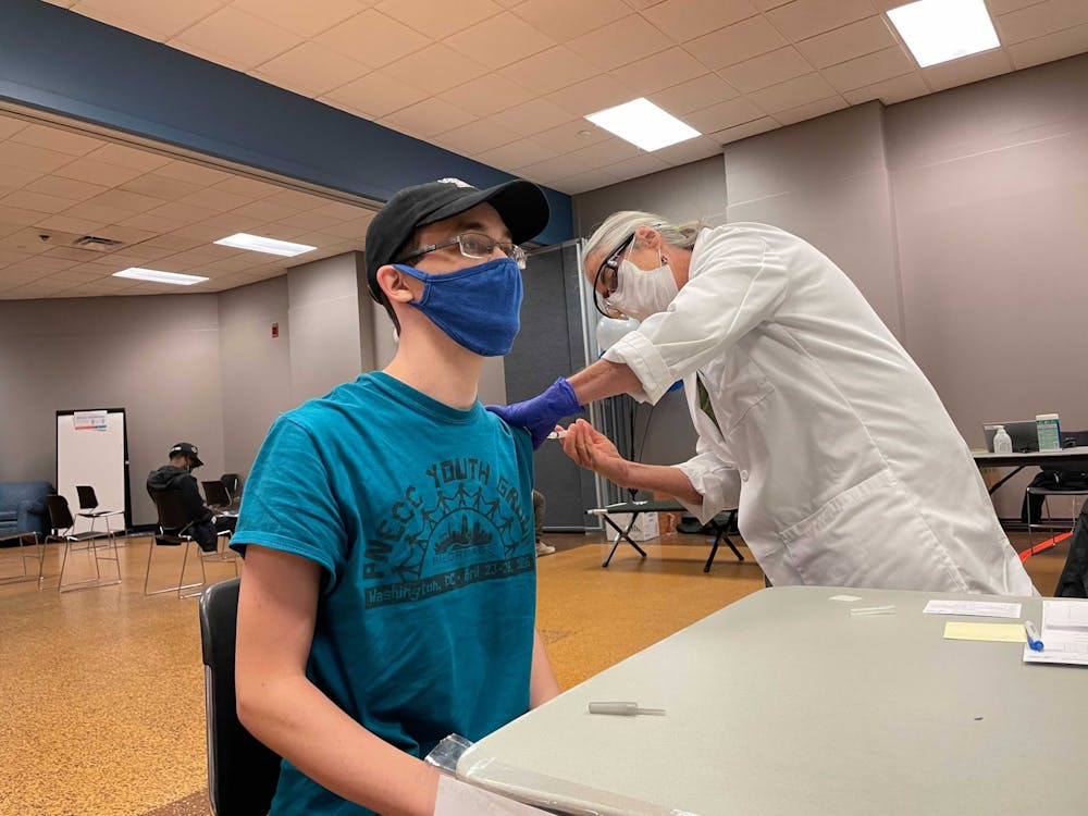 Josh Atkinson, a senior geology major, receives the Johnson & Johnson vaccine at UB's North Campus vaccination site.