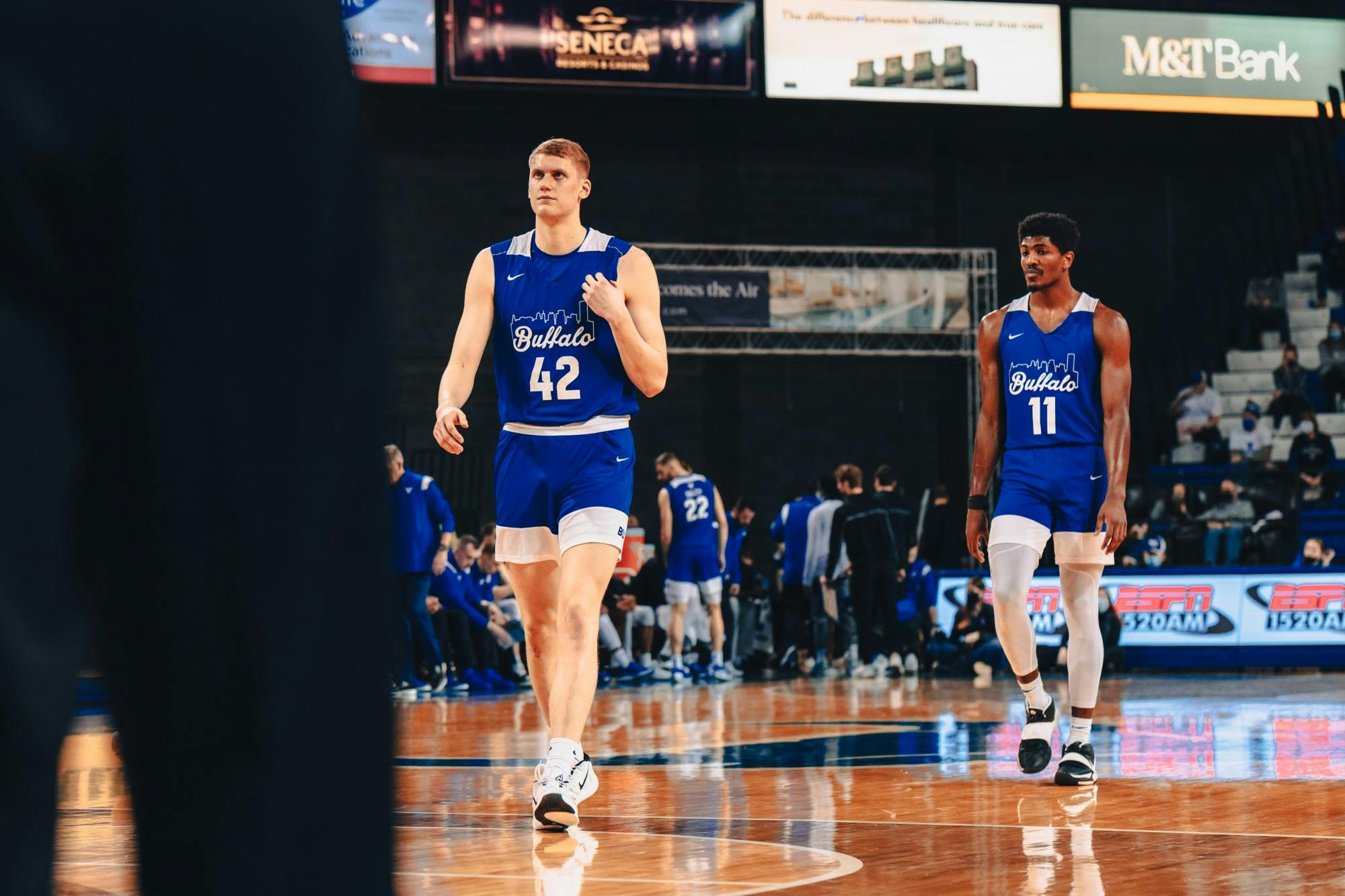 Redshirt sophomore center David Skogman (42) and senior forward Jeenathan Williams (11) walk off the Alumni Arena court.