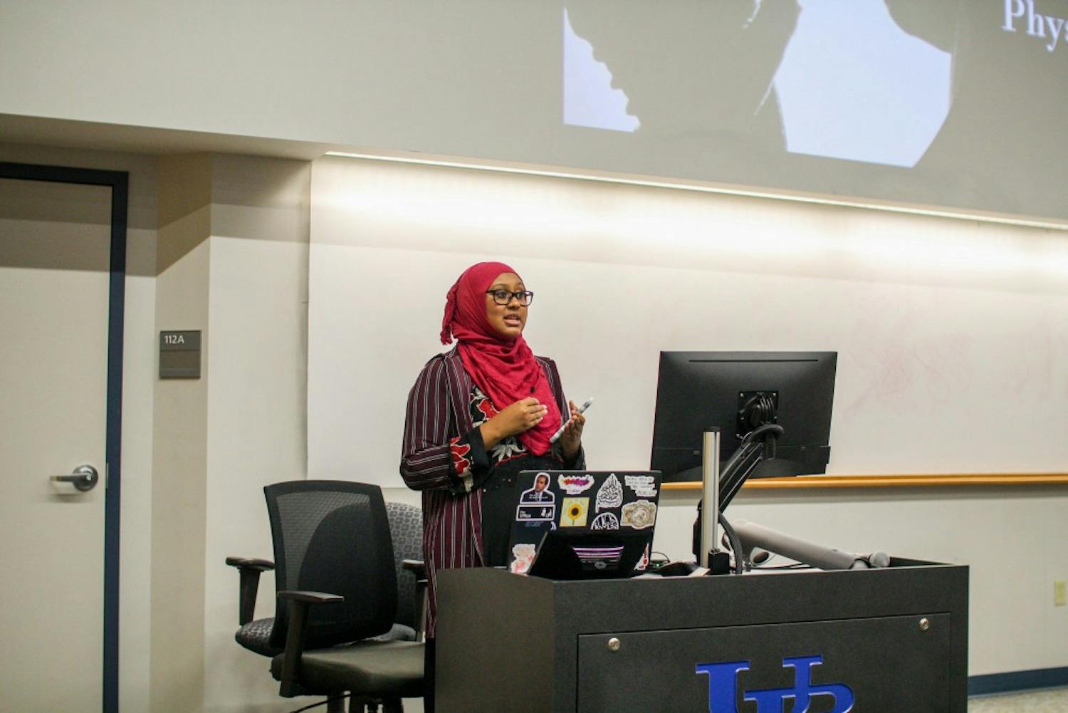 Muslim Student Association member Ilhan Noor introduces guest speaker April Arman.
