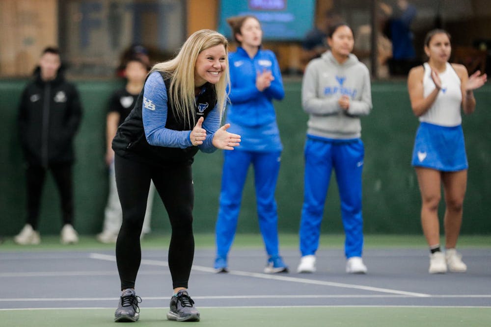 <p>Women’s tennis coach Kristen Maines coaching her team.</p>