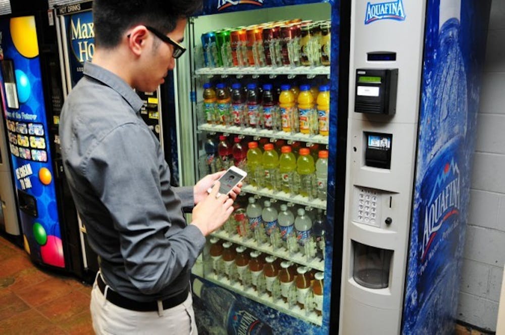 David Le uses a mobile application to access his ID card, allowing him to purchase items from vending machines through his phone.&nbsp;Courtesy of Steve Morse