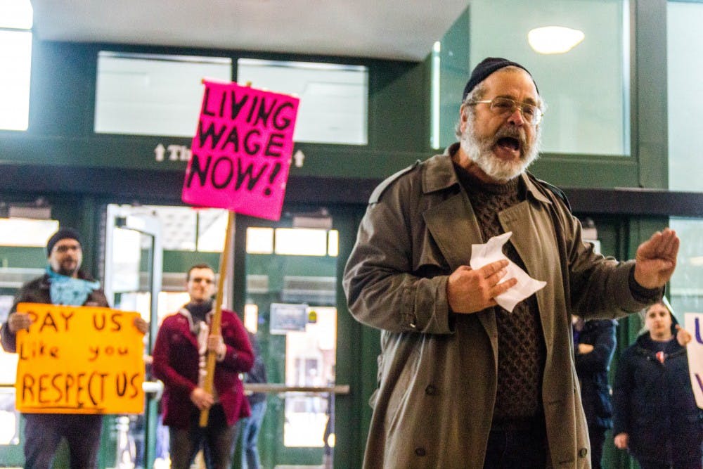 <p>English Professor Jim Holstun stands in the center of the living stipend rally to voice support for graduate students asking for livable wages. Roughly 30 UB community members attended the rally, which took place Sunday on Accepted Students Day.</p>
