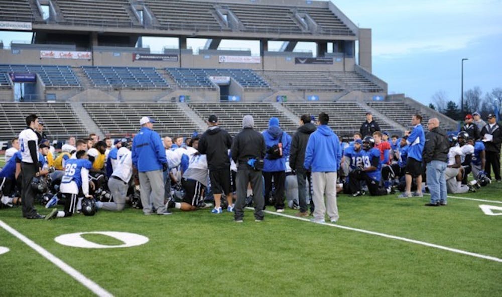 The football team gathers together at the end of the practice Sunday. The Bulls&rsquo; game against Kent State was canceled by the MAC after Kent State&rsquo;s equipment truck was unable to reach Buffalo due to road closings caused by the lake effect snowstorm.&nbsp;Yusong Shi, The Spectrum