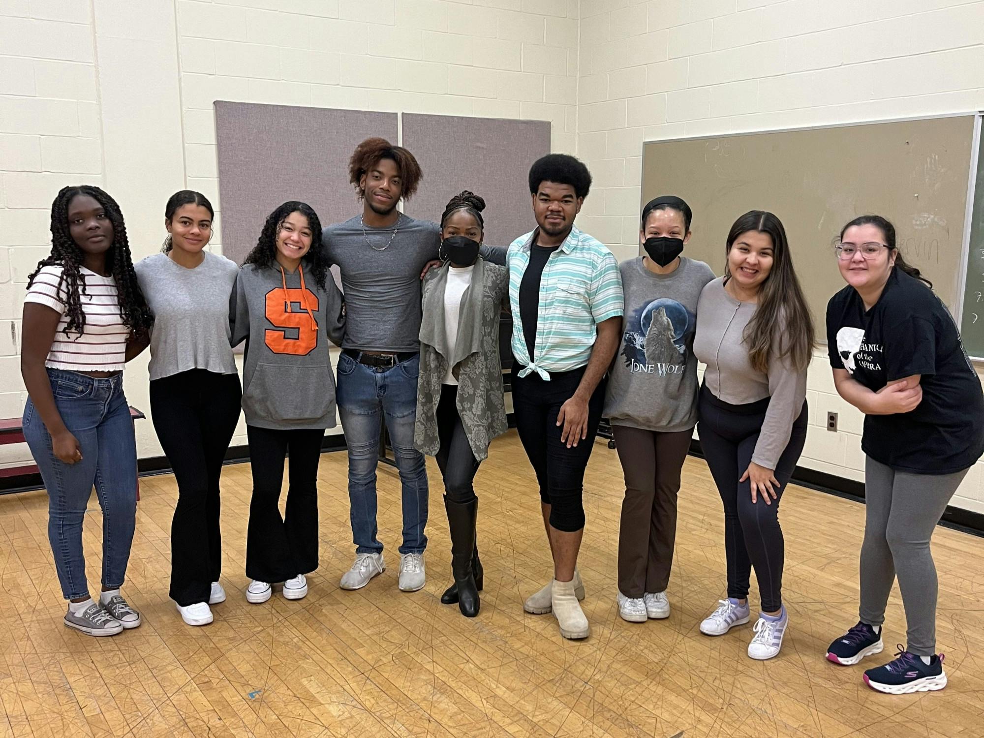 Student-members of Dreams Affirmed pose for a photo with Broadway actress Karen Burthwright (center).