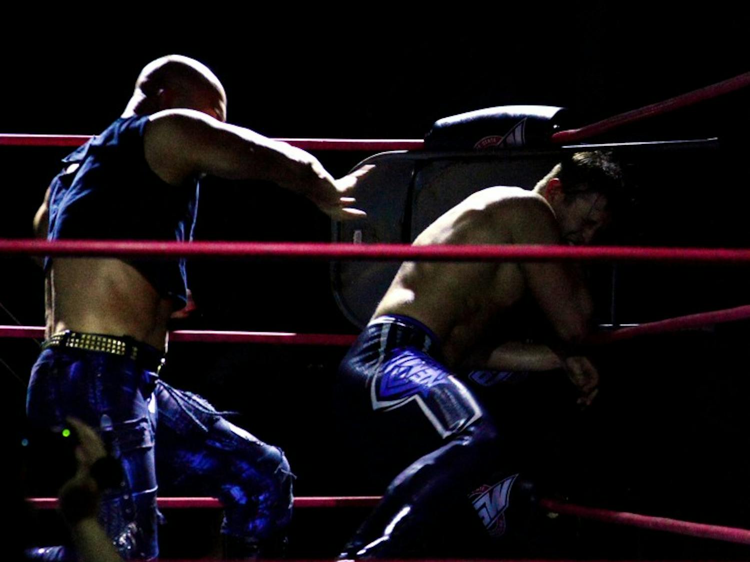 Jesse Guilmette throws his opponent into a steel chair in the corner of the ring. Guilmette teaches the advanced class at Grapplers on Wednesday nights.