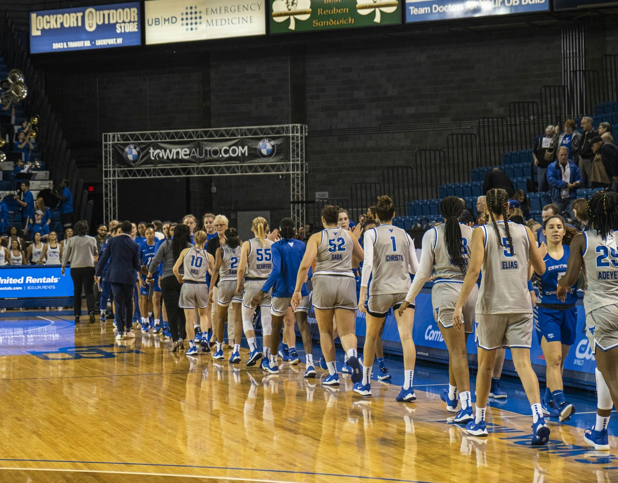 The women’s basketball team congratulates an opponent at the end of a game.