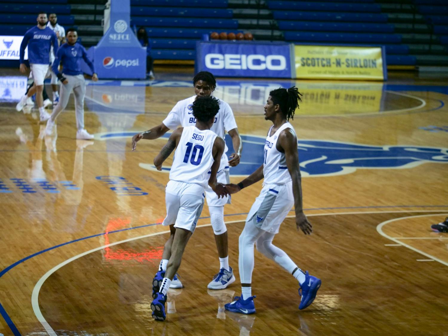 While Josh Mballa dominated inside, junior forward Jeenathan Williams and junior guard Ronaldo Segu (10) provided the Bulls with a considerable boost from three-point range.