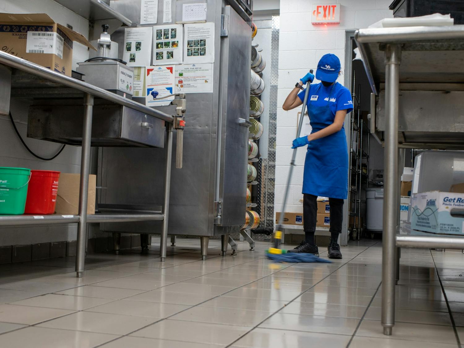 A CDS employee mops the floor in one of UB’s on-campus kitchens.&nbsp;