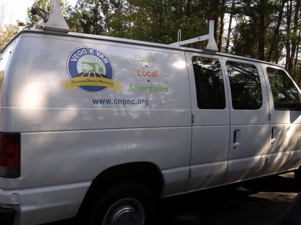 The Veggie Van hosts weekly mobile farmers markets, offering underserved neighborhoods access to cheap, healthy produce. Left: Bins of fresh produce at one of the van’s sales.