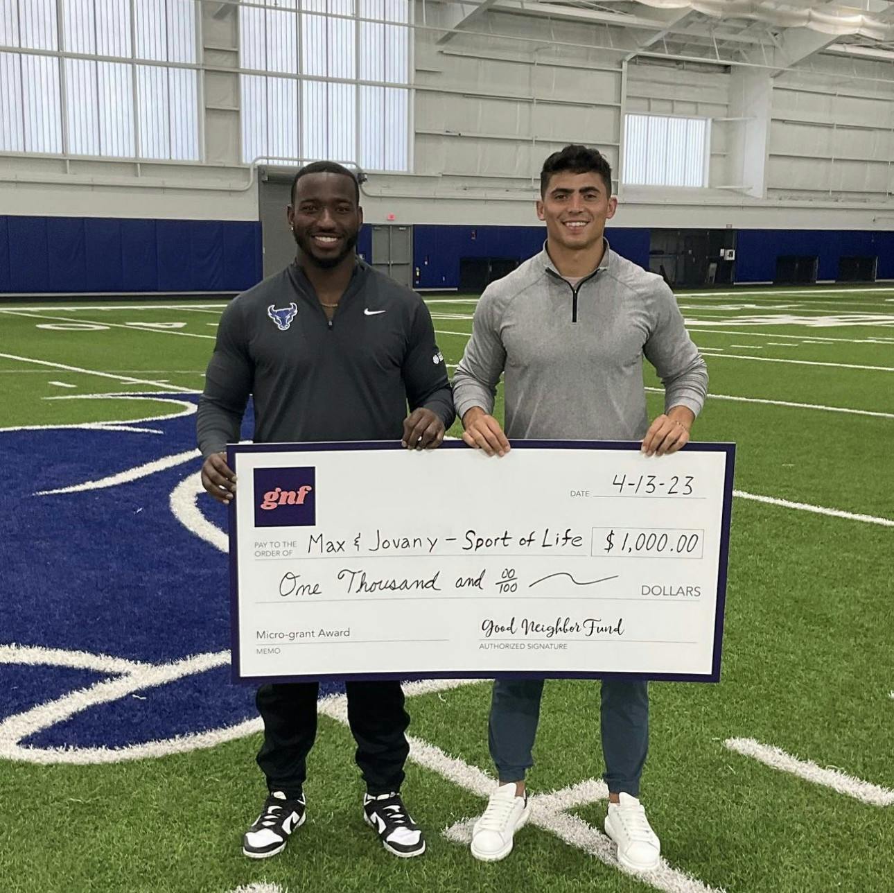 Sport of Life co-founders Max Michel (left) and Jovany Ruiz (right) with a $1,000 check from the Good Neighbor Fund.&nbsp;