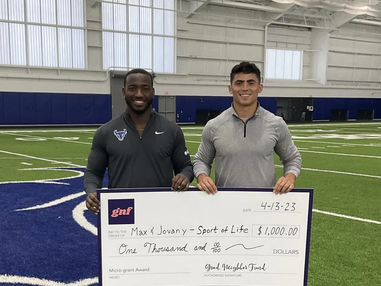 Sport of Life co-founders Max Michel (left) and Jovany Ruiz (right) with a $1,000 check from the Good Neighbor Fund. 