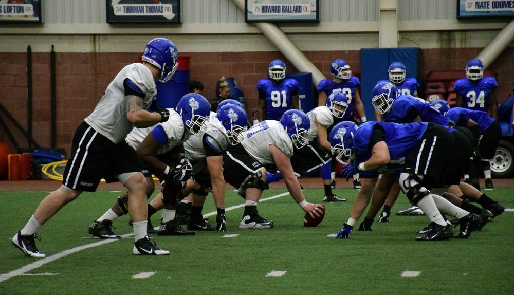 <p>The football team practices in the ADPRO Sports Training Center on Wednesday. Three offensive linemen will graduate at the end of the year, leaving the entire left side of the line to be filled by unproven underclassmen and upperclassmen.</p>