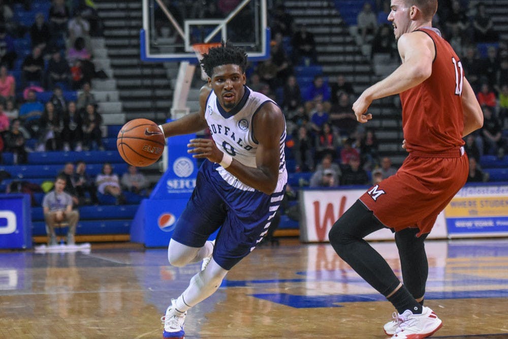 <p>Senior wing Blake Hamilton dribbles past a&nbsp;Miami player. Hamilton led the way during Saturday's game&nbsp;with 23 points.</p>