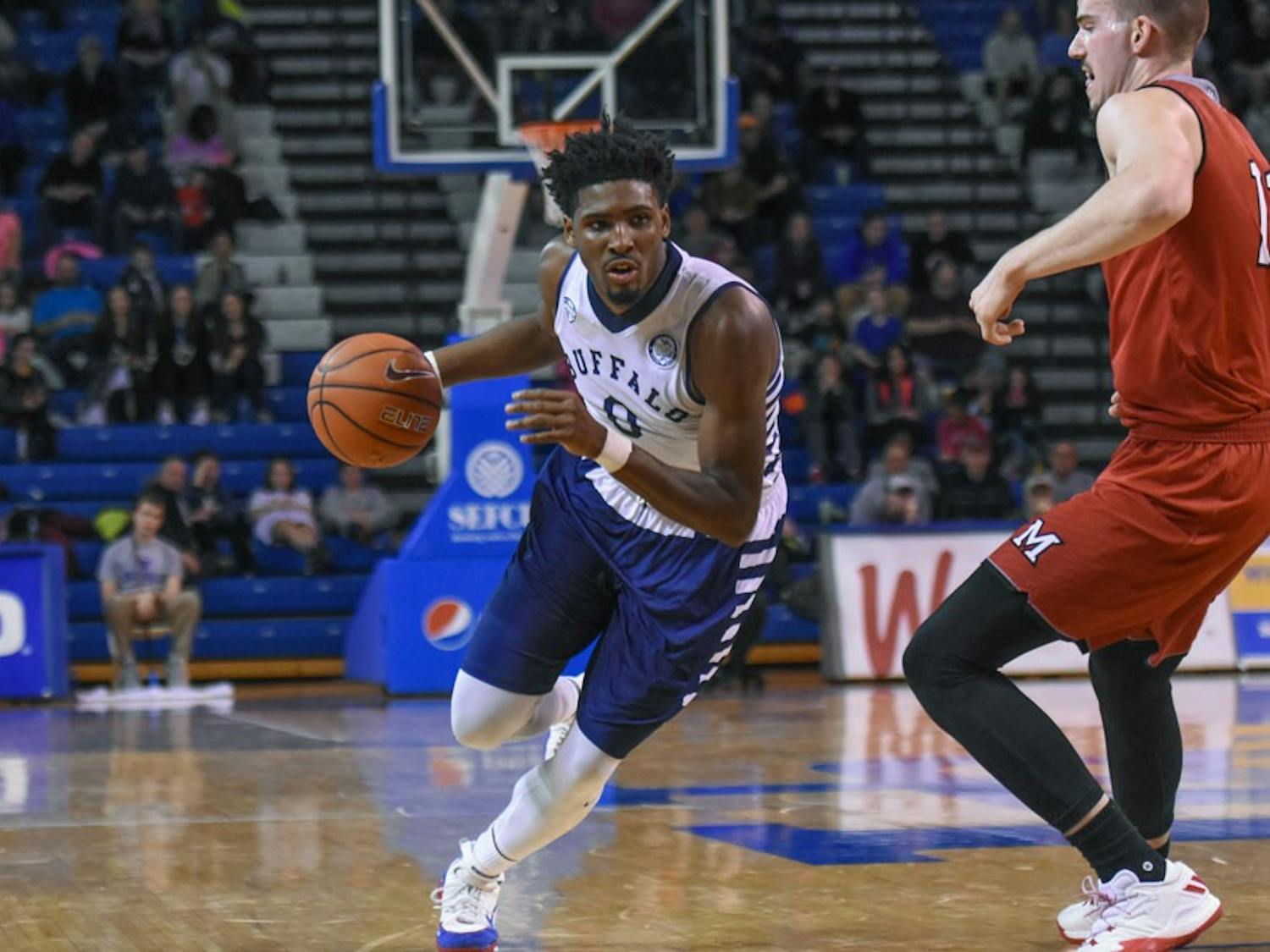 Senior wing Blake Hamilton dribbles past a Miami player. Hamilton led the way during Saturday's game with 23 points.