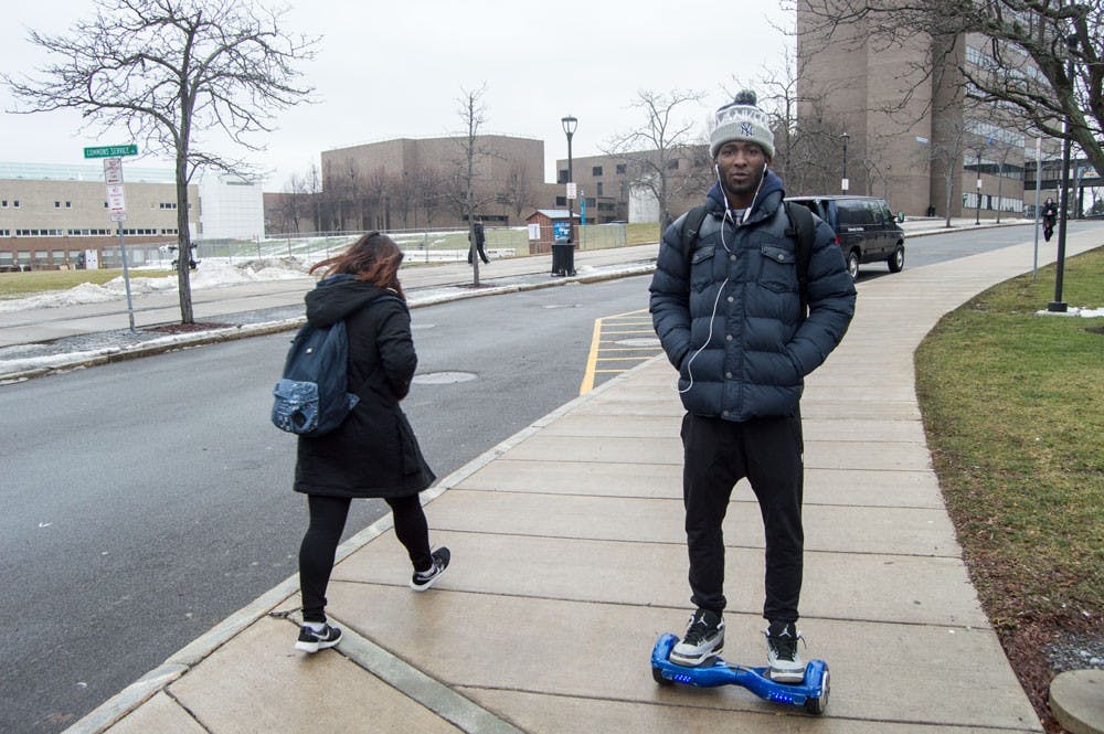 <p>Antwann Kearse, a junior in business management, rides his hoverboard on campus. UB recently banned hoverboards in the dorms and apartments, citing fire hazards.&nbsp;</p>