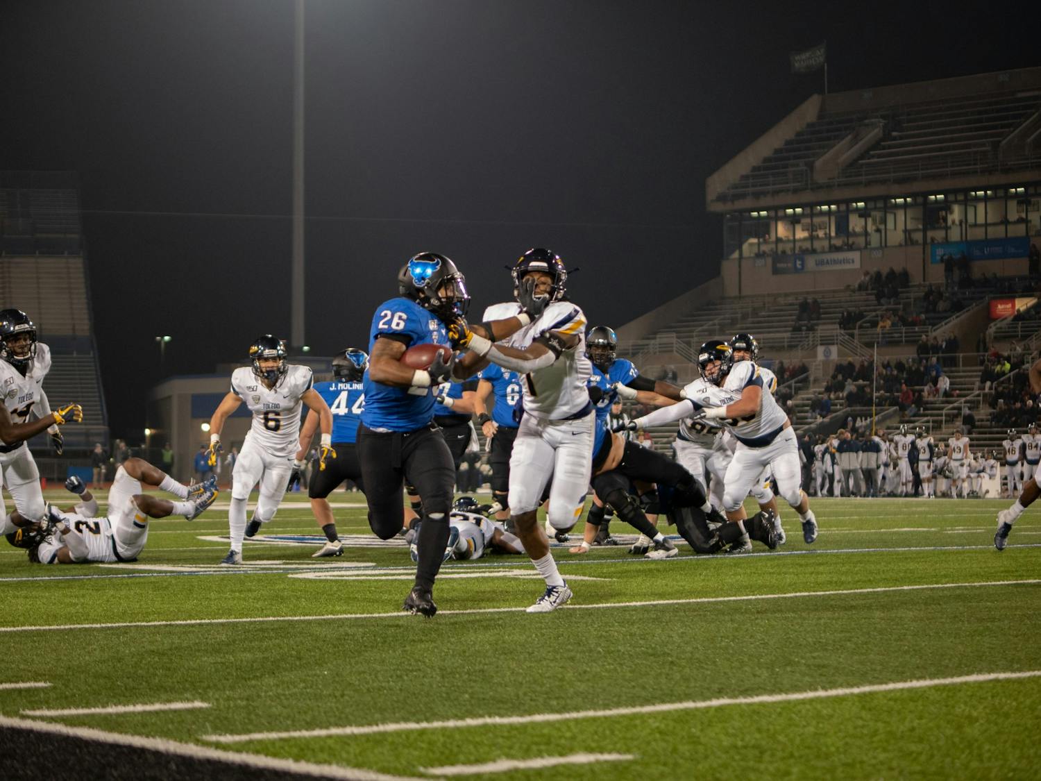 Running back Jaret Patterson holds a defender off him.