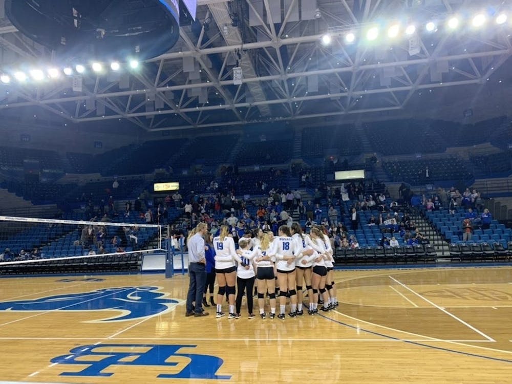 <p>Players stand in the middle of the court during volleyball’s senior night Saturday.</p>