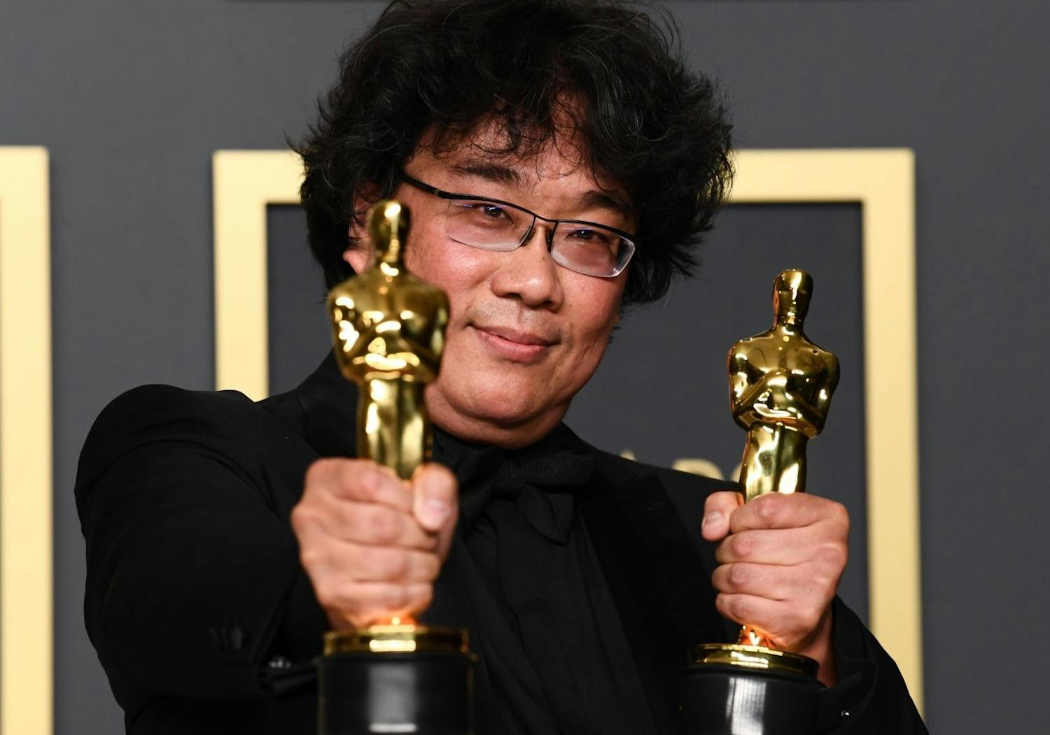 “Parasite” director Bong Joon Ho holds two Oscars.