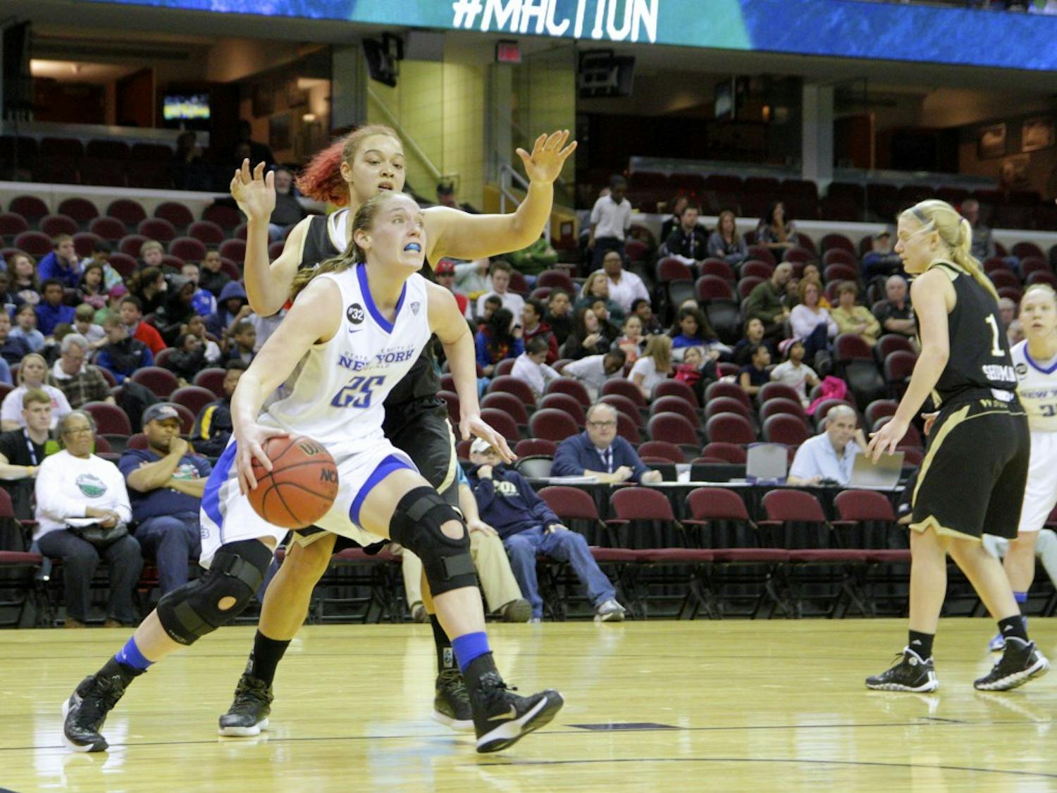 Senior forward Kristen Sharkey drives past a Western Michigan defender toward the basket.