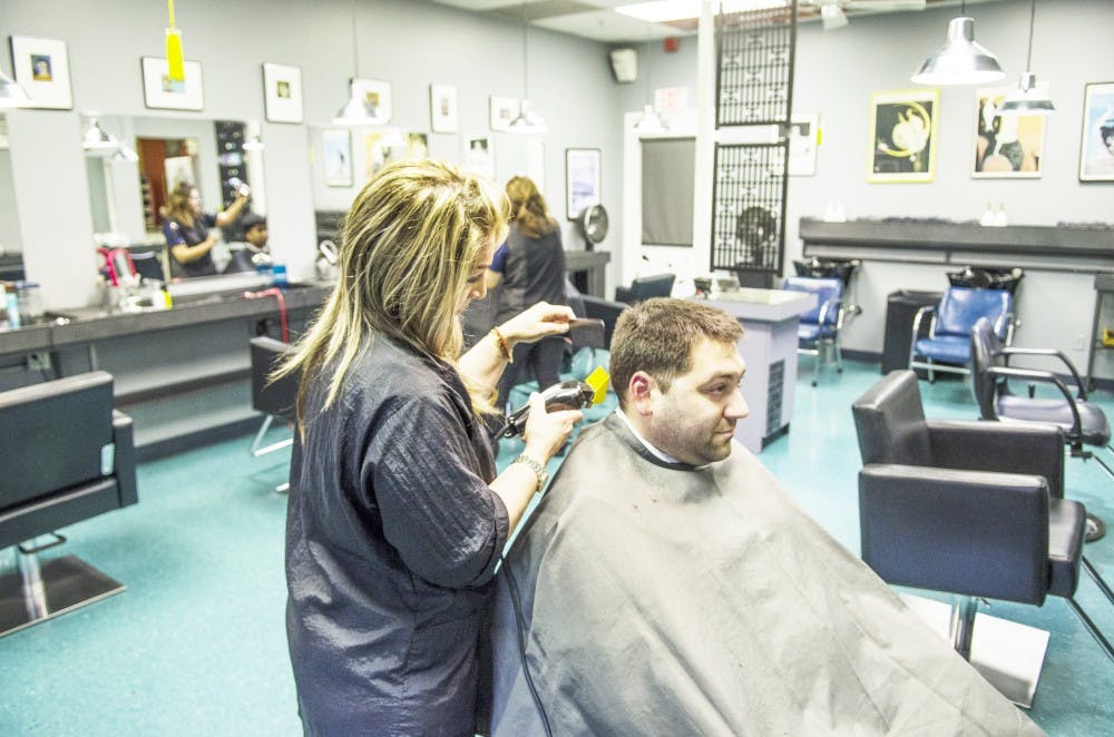 <p>Freddie Rivera, who graduated from UB, gets his hair cut at Rosanne’s in The Commons.</p>