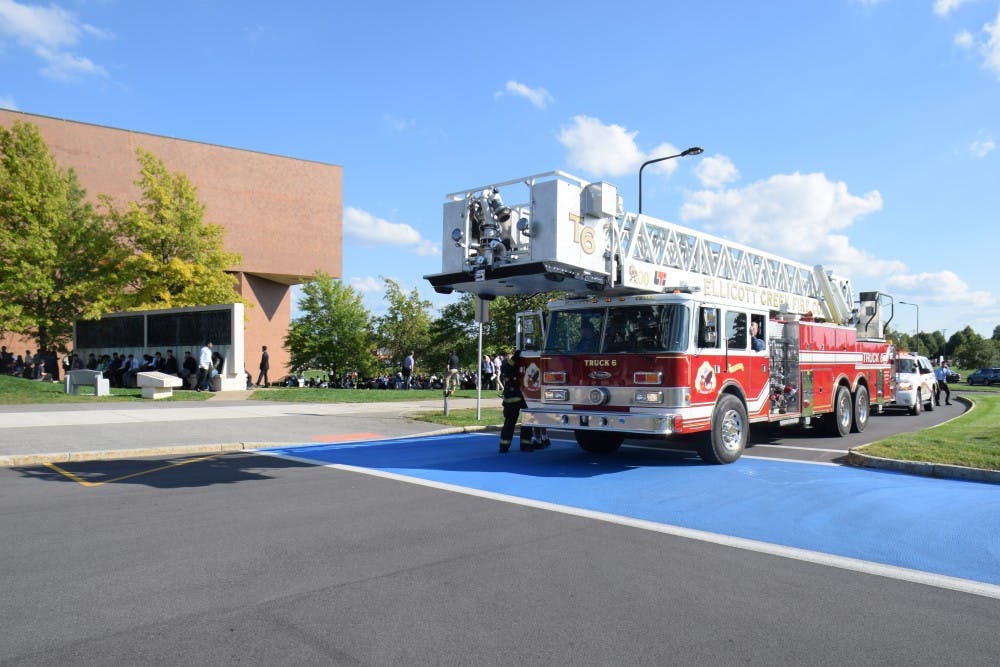<p>A firetruck sits outside of Alumni Arena as students and faculty wait outside.&nbsp;The building&nbsp;is currently closed after an electrical transformer on the north end of the building burned out.</p>