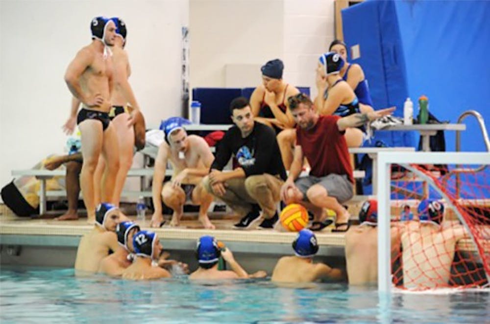 <p>Members of the Buffalo water polo team huddle near the end of the pool in Alumni Arena. The club team is currently in its first season as a part of the Collegiate Water Polo Association.</p>