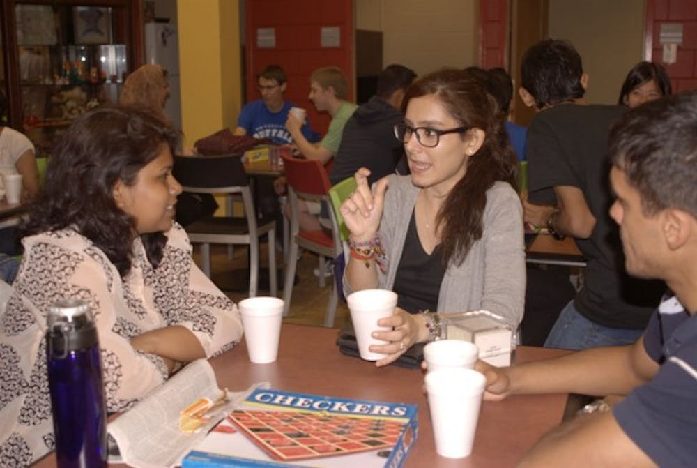 Azadeh Dinparastjadid, a graduate student in mechanical engineering, sits around the table with some newfound friends at International Tea Time. International and local students gather in SU 220 every Wednesday for tea, games and conversation.&nbsp;Emily Li, The Spectrum