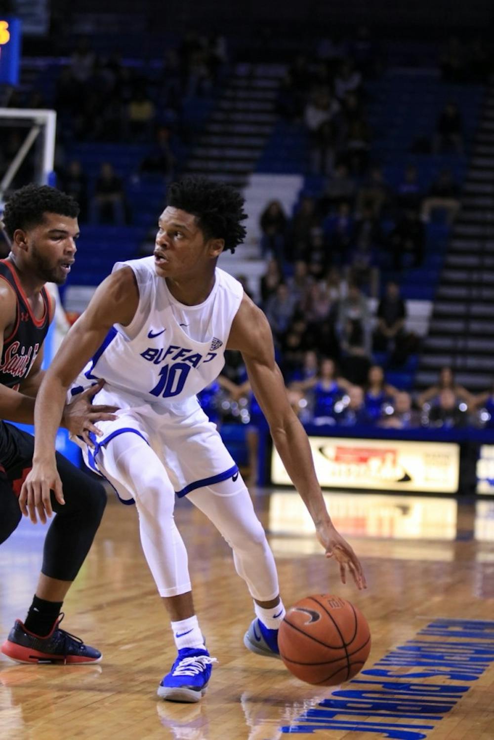 <p>Freshman guard Ronaldo Segu posts up on a Saint Francis player. The Bulls are 3-0 after Monday night’s 62-53 win over the Southern Illinois Salukis.</p>