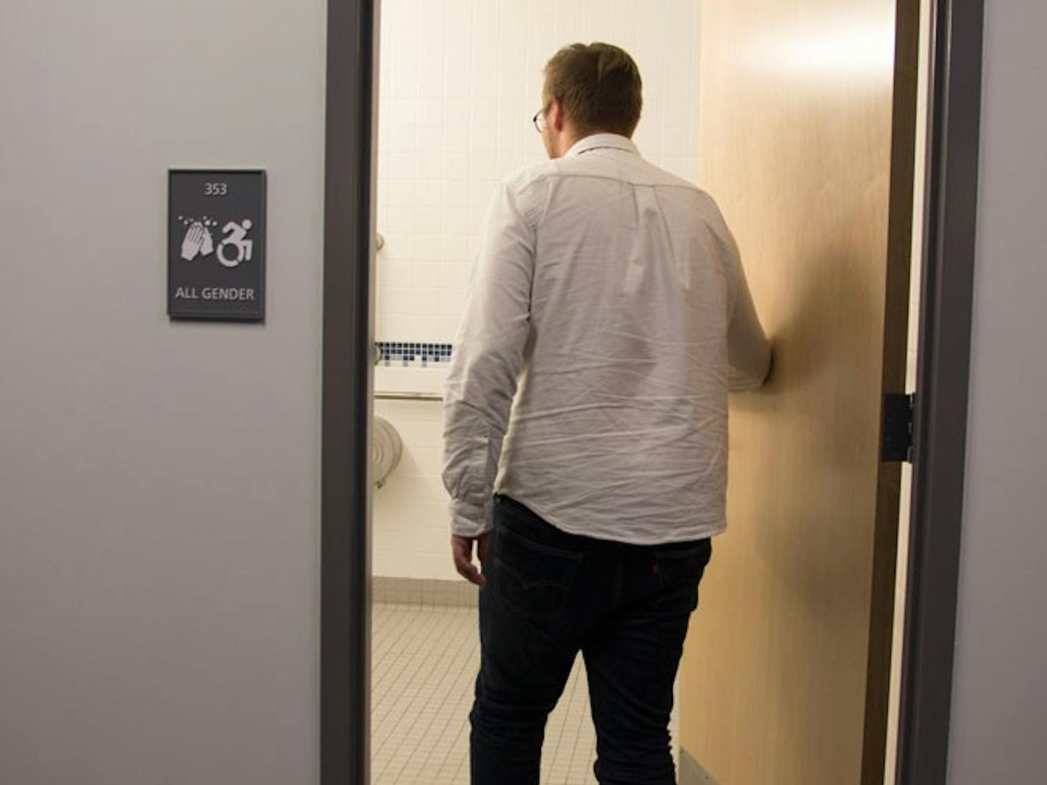 A UB student walks into the new gender-neutral bathroom in the Oscar A. Silverman Library.&nbsp;UB recently introduced gender-neutral bathrooms in the library located in Capen Hall.&nbsp;
