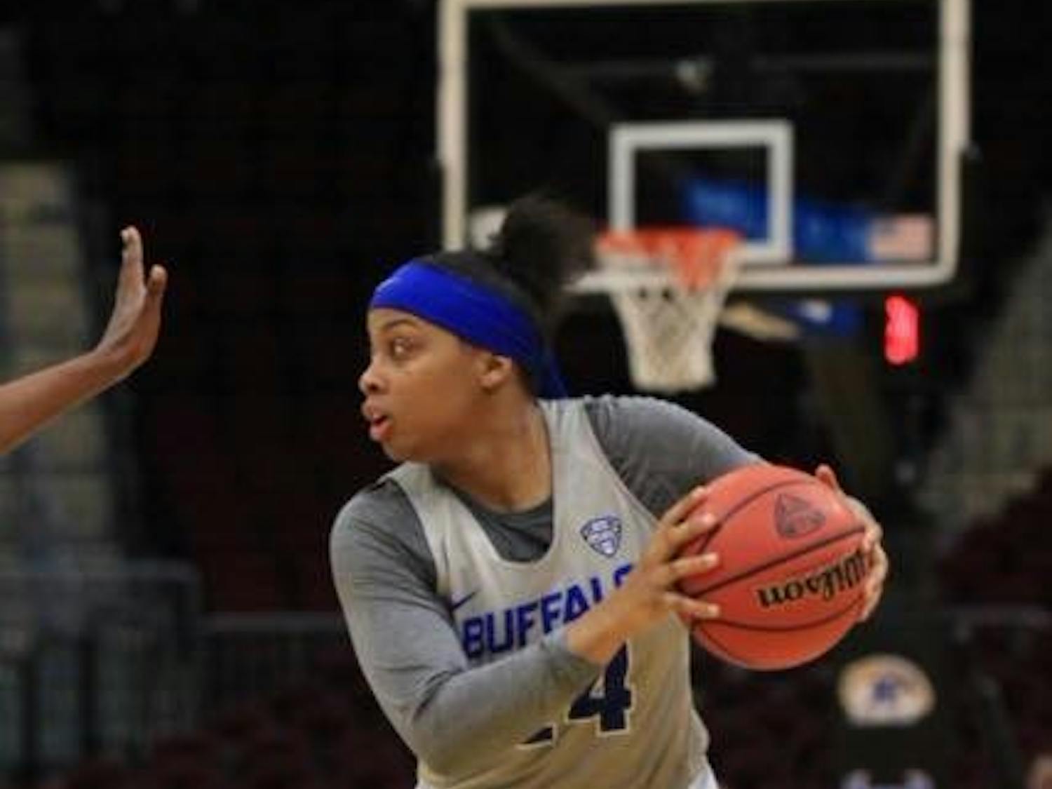 Junior guard Cierra Dillard looks for an option as defender post-up to her. Dillard was the lead scorer in the Bull's first NCAA Tournament win on March 17 against the South Florida Bulls.