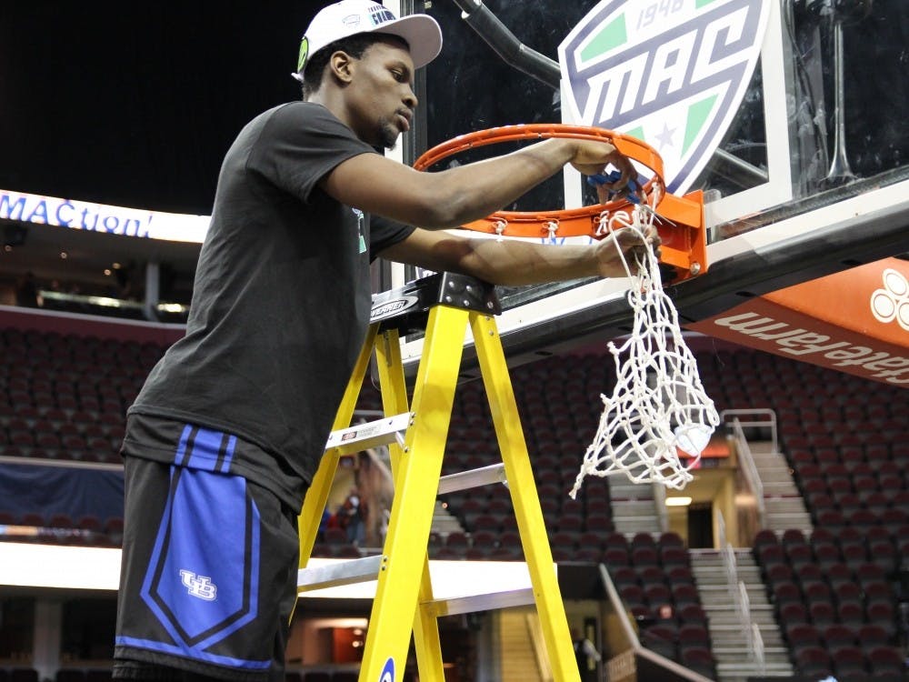 Xavier Ford cuts down the net after Buffalo's 89-84 MAC championship victory over Central Michigan Saturday in Quicken Loans Arena. Ford has made an impact for the Bulls this season after struggling his first three seasons. 