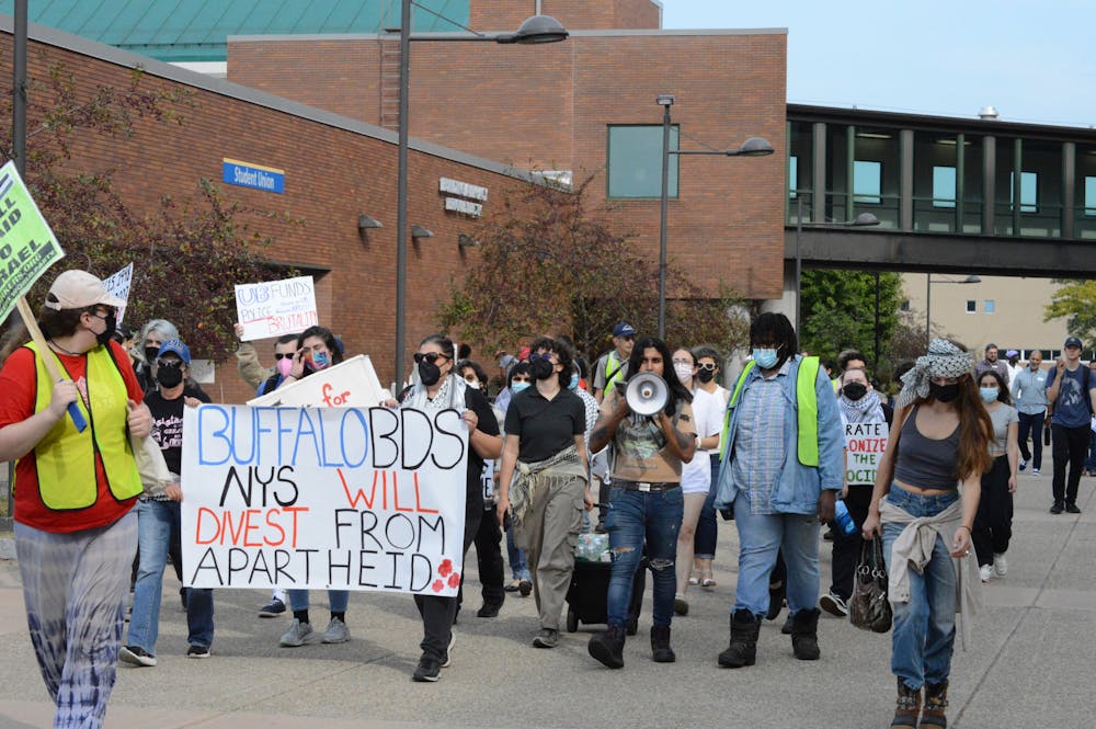 Demonstrators walk down the Academic Spine on Friday, Sept. 20, 2024.