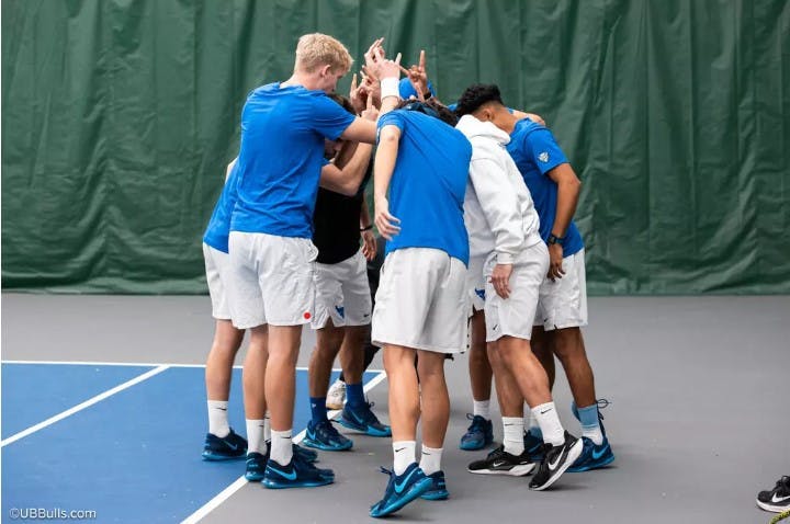 Men's tennis huddle.