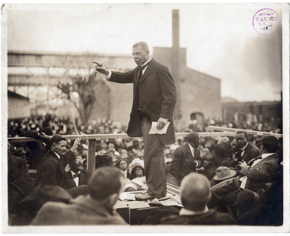 American educator, economist, and industrialist Booker T Washington (1856 - 1915), speaks to a large crowd during his last pilgrimage in Louisiana, during one of his southern educational tours, circa 1915. Washington founded the Tuskegee Institute in Alabama. (Photo by Arthur P. Bedou/Robert Abbott Sengstacke/Getty Images)