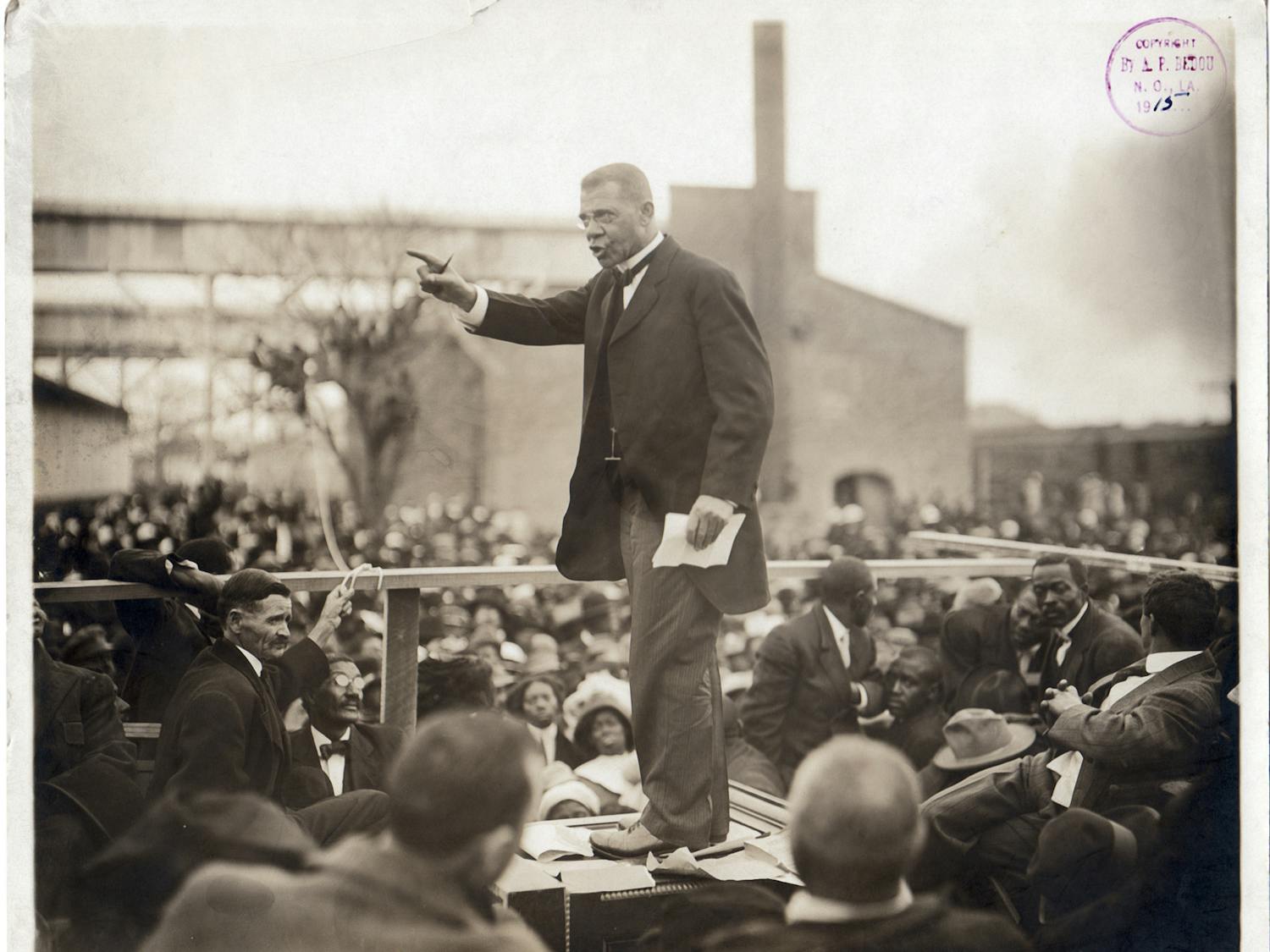 American educator, economist, and industrialist Booker T Washington (1856 - 1915), speaks to a large crowd during his last pilgrimage in Louisiana, during one of his southern educational tours, circa 1915. Washington founded the Tuskegee Institute in Alabama. (Photo by Arthur P. Bedou/Robert Abbott Sengstacke/Getty Images)
