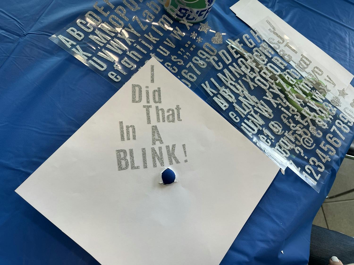 UB seniors decorating their graduation caps in the Student Union.