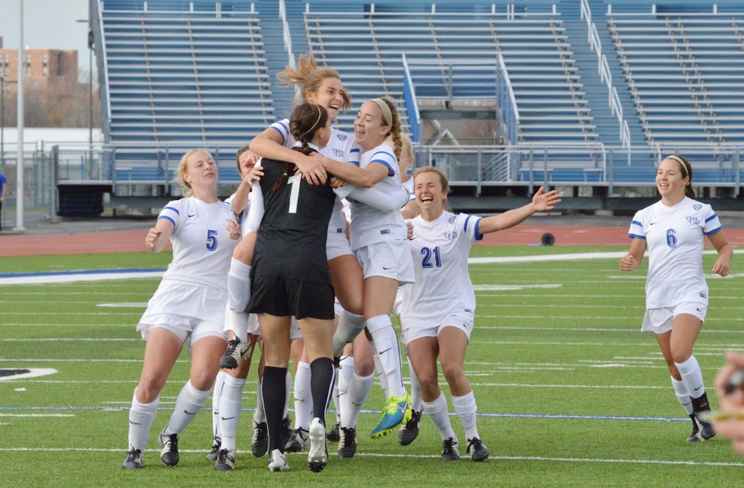 Members of the 2015-16 women’s soccer team celebrate on the pitch at UB Stadium. Over spring break, the Bulls will embark on a seven-day, three-city tour through Spain.