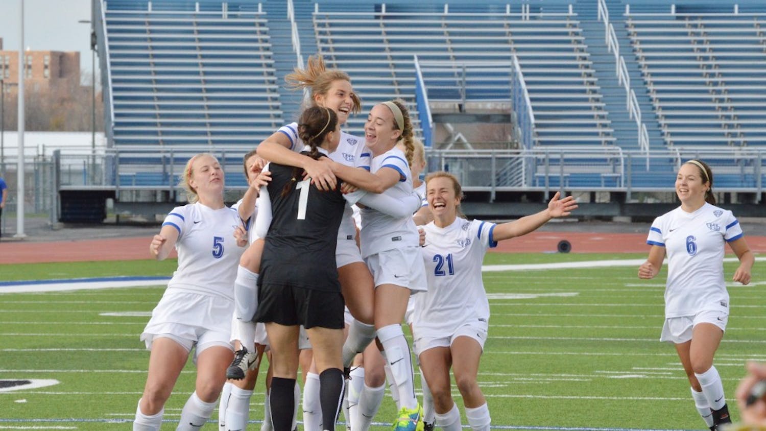 Members of the 2015-16 women’s soccer team celebrate on the pitch at UB Stadium. Over spring break, the Bulls will embark on a seven-day, three-city tour through Spain.