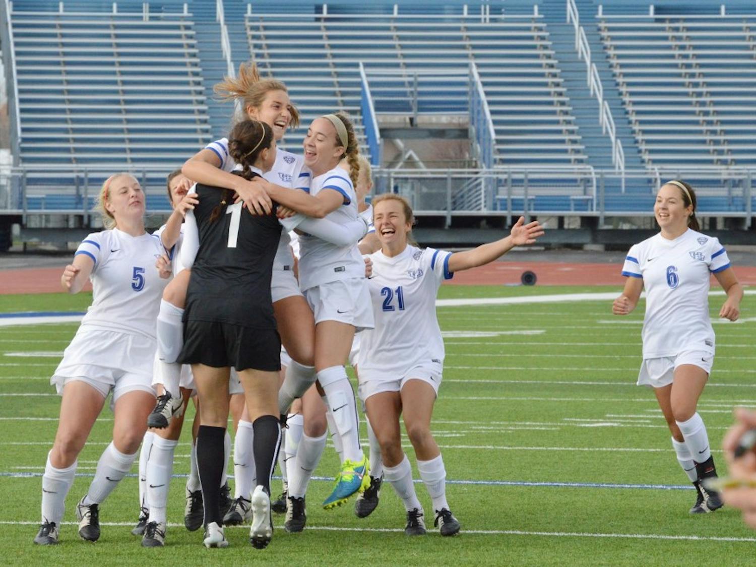 Members of the 2015-16 women’s soccer team celebrate on the pitch at UB Stadium. Over spring break, the Bulls will embark on a seven-day, three-city tour through Spain.