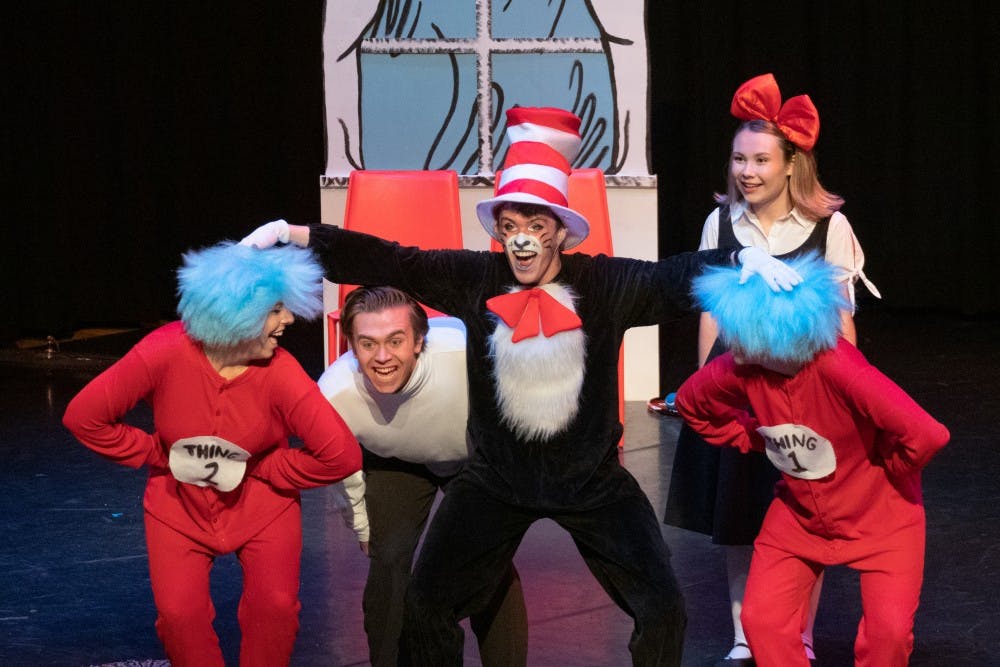 <p>Dr. Seuss characters Sally, Conrad, Thing 1, Thing 2 and The Cat in the Hat on stage.</p>