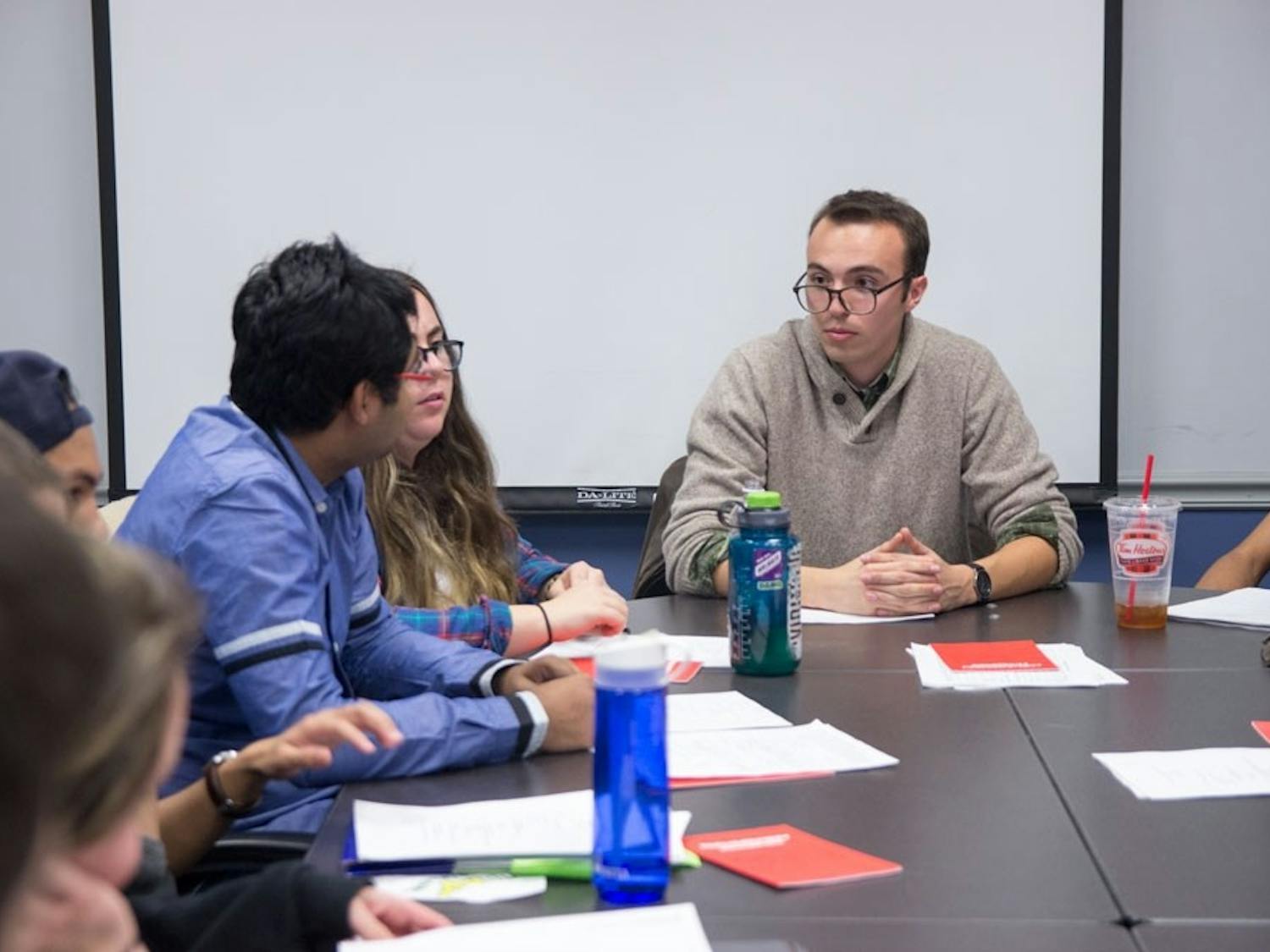 Senate Chair Dillon Smith (right) listens to senators speak during an SA Senate held in the fall semester. The senate is currently looking to fill the vacant senate seat left by former senator Yaser Soliman. 